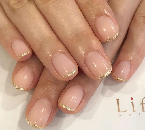 Image of a champagne gold micro french tips nails